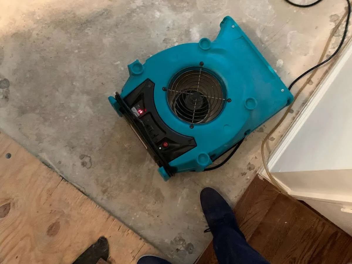 Air mover drying subfloor during Commercial Water Damage Restoration in Hollister